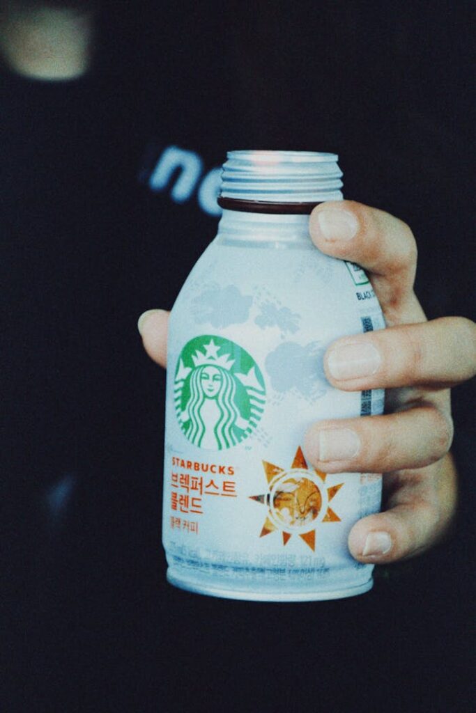 Close-up of a hand holding a Starbucks coffee bottle, shot in South Korea.