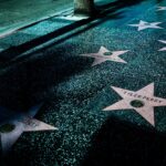Night view of Hollywood Walk of Fame stars showcasing celebrity names and iconic design.