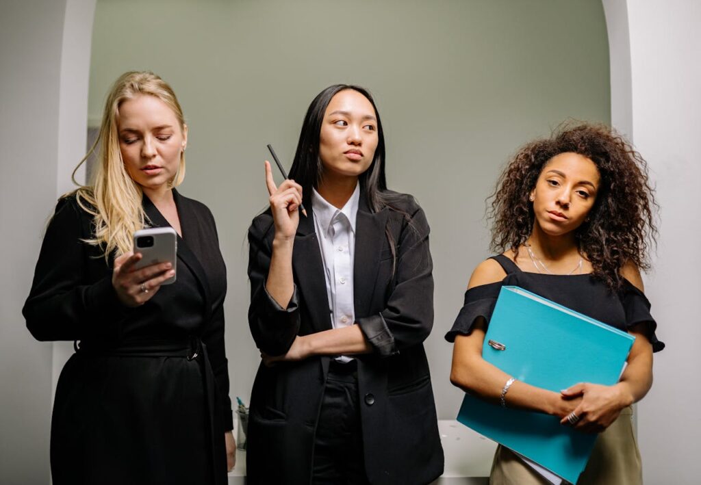 pexels-photo-7640428 Three diverse businesswomen in professional attire in an office setting.